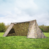DD A-Frame Tent in Multicam pattern set up in a grassy outdoor environment, ideal for camping.